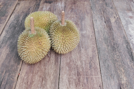 durian ripe fruit  which has thorn on the wood board background. Top viewの写真素材