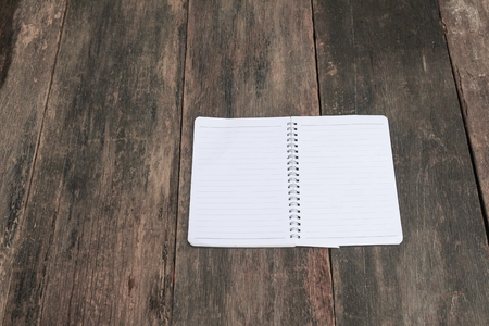 notebook paper on wooden table, business conceptの写真素材