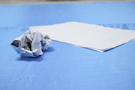 Crumpled paper lump and texture on blue table background in business  meeting  room  with copy spaceの写真素材