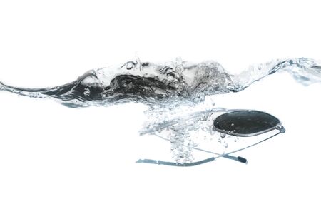 glasses fall in water splash bubbles show  motion on white background, with copy space.の写真素材