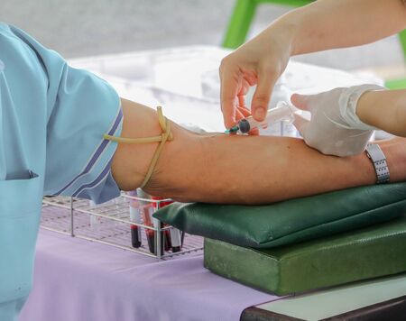 doctor injection needle selective focus syringe on arm to collect blood for test the healthの写真素材