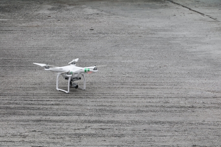 white drone with high resolution digital camera  on the cement floor
