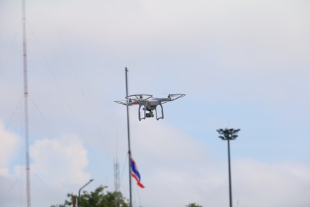 white drone motion hovering in  blue sky