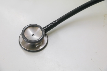medical stethoscope in Clinic, old used long-standing on the table with copy space :Select focus with shallow depth of field.の写真素材