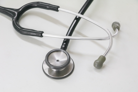 medical stethoscope in Clinic, old used long-standing on the table with copy space :Select focus with shallow depth of field.の写真素材