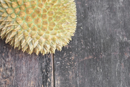 durian ripe fruit which has thorn close up, on the wood board background. with copy space for add textの写真素材