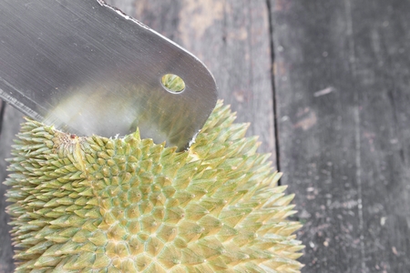 durian and knife peeled  of fruit on the wooden table floor with copy space for add textの写真素材