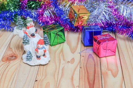Christmas day with snowman gift  happy new year  on  wooden backgroundの写真素材