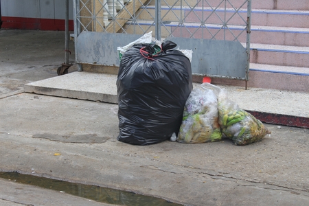 Pile of black garbage bag and Vegetable rot