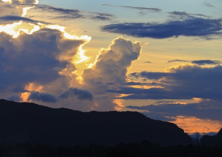 sky in sunset and raincloud  colorful twilight time  with mountain silhouette, art beautiful in...