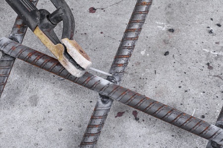 welding Steel,  on concrete floor  in construction site