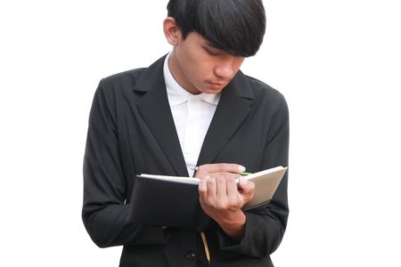 Businessman  handsome in hand signing record document with notepad on white backgroundの写真素材