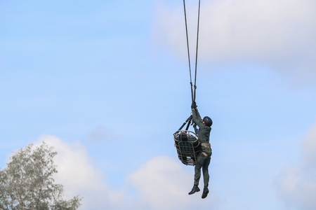 Soldier rescue emergency by army helicopter with rope  on blue skyの写真素材