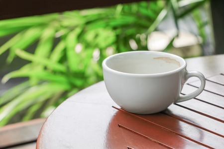 coffee cup on the wood floor backgroundの写真素材