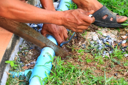 plumber cut  repair plumbing broken pipe. select focus sawの写真素材
