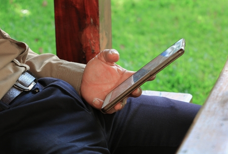 Close up of businessman using mobile smart phoneの写真素材