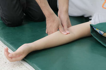 Deep tissue massage on arm closeup