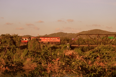 train on a bridge over river   with vintage sunset color tone and copy space add textの写真素材