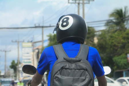 close up man driving the motorcycle with helmet  black  on roadの写真素材