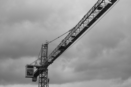 black and white image of  Tower crane silhouette construction with heavy industrialの写真素材
