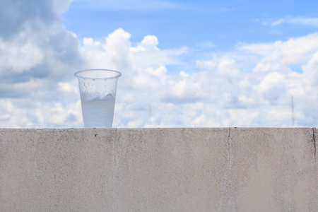 ice in glass-plastic on the floor with blue sky  backgroundの写真素材