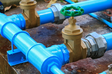water valve plumbing joint  steel tap pipe with green knob close upの写真素材