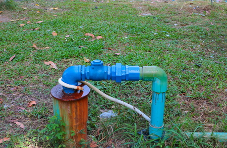 water valve plumbing steel have repair pipes with modify of joined and painted blue on the grassの写真素材