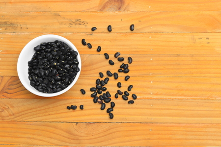 black beans in  bowl on wood floor backgroundの写真素材
