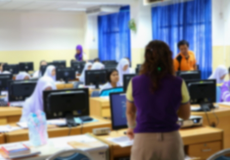 focus blur, the student with teacher learning business technology desktop computer in a classroom