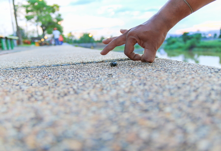 Ok hand sign. on stone in the public park select focus with shallow depth of field