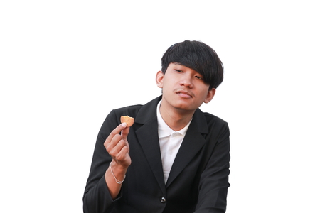 Young man handsome  eat cookie small pieces on  white backgroundの写真素材