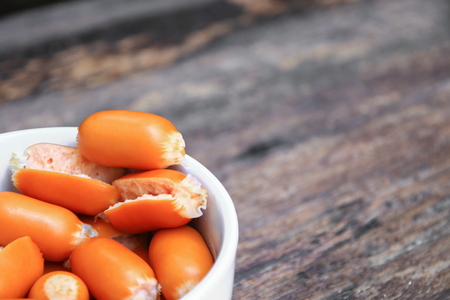 sausages boiled macro focus in white bowl on the wooden background.の写真素材