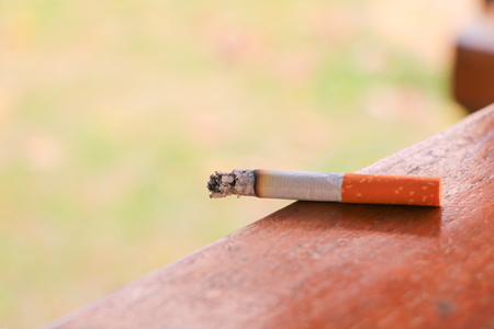 Cigarette burn selective focus on a wooden table concept Health A day to stop smoking the world.の写真素材