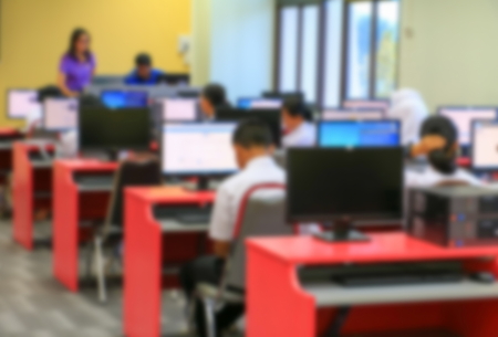 focus blur, the student with teacher learning business technology desktop computer in a classroomの写真素材