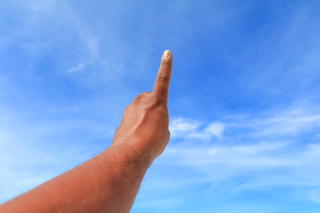hand show counting number one on sky backgroundの写真素材