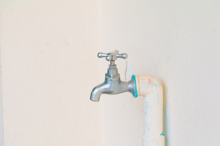 faucet color silver - bronze and old pipe in wall cement background with copy space add textの写真素材