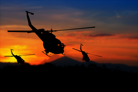 soldier silhouette in rappelling climb down from helicopter on sunset with copy space add textの写真素材