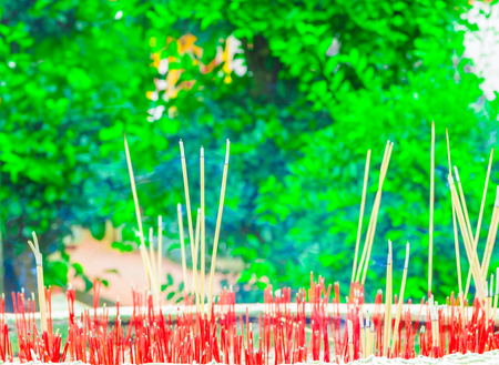 close up incense red stick in pot select focus with shallow depth of field.の写真素材