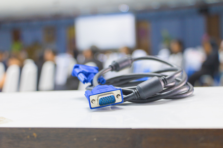 old dirty VGA  tech cable  connector of computer on table white Blur meeting room background