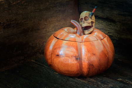 skull on pumpkin made of wood in Halloween day concept background. still life style with copy space add text ( full High definition  Photo)の写真素材
