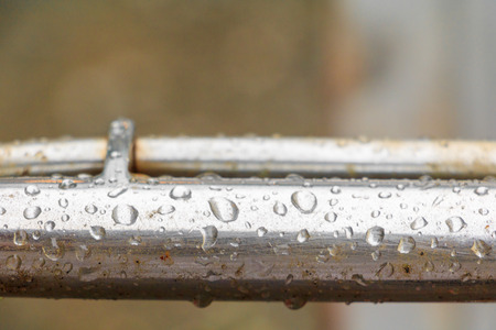 water drops on old metallic steel pipe aluminum background with copy space add text