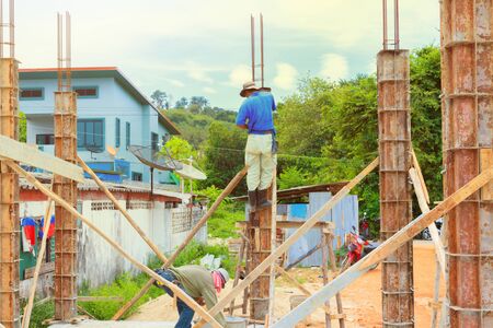 construction workers collaborating in the installation formwork workplace build a houseの写真素材