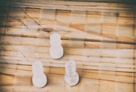chess glass on board in game. On a vintage wooden floor background vintage scratched old film...