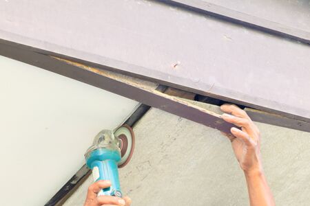 hand technician repairing ceiling with Grinding wheel interior home