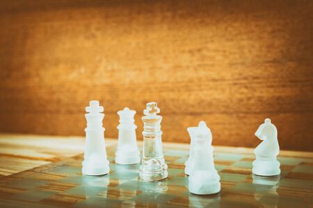chess glass on board in game. On a vintage wooden floor background vintage scratched old film colors. Concept competition business success. with copy space add textの写真素材