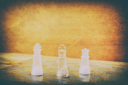 chess glass on board in game. On a vintage wooden floor background vintage scratched old film colors. Concept competition business success. with copy space add textの写真素材