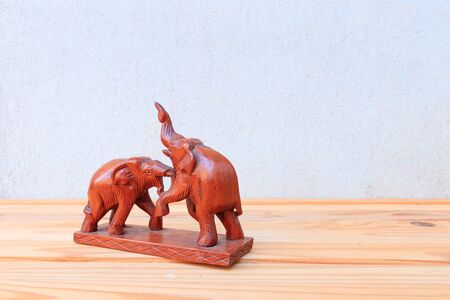 two wooden elephant conflict on wood floor table background with copy space add textの写真素材