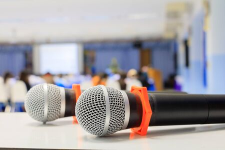 Close up microphone wireless old on the table in the conference and Background blur interior seminar meeting roomの写真素材