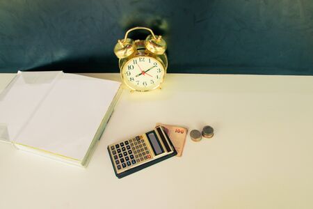 calculator old, money and alarm clock old vintage gold over white and black background. with copy space add text. color vintage style toneの写真素材