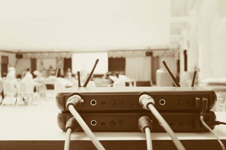 Close up Jack plug cables connected with old box of wireless microphone in conference meeting room...